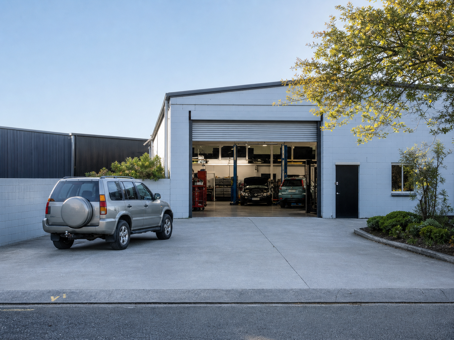 Generated placeholder showing a modest local automotive workshop exterior.